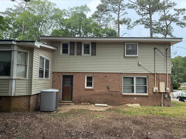 4909 Yaupon Cir, Myrtle Beach, SC 29575 - rear view of property featuring cooling unit and brick siding