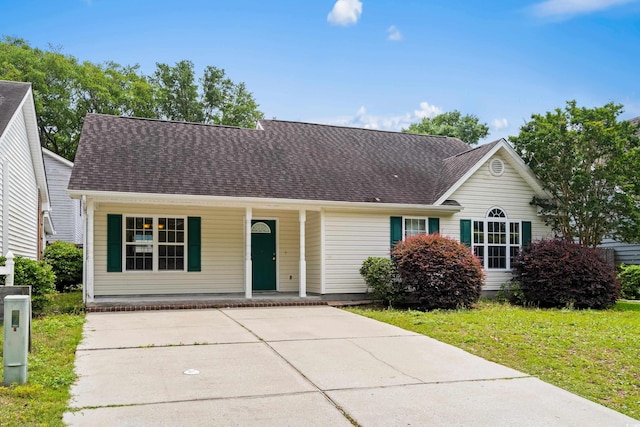 9580 Kings Rd, Myrtle Beach, SC 29572 - view of front facade featuring covered porch, roof with shingles, a front lawn, and driveway