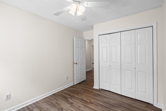 9580 Kings Rd, Myrtle Beach, SC 29572 - unfurnished bedroom with dark wood finished floors, a closet, and ceiling fan