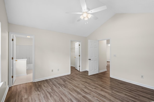 9580 Kings Rd, Myrtle Beach, SC 29572 - unfurnished bedroom featuring wood finished floors, a spacious closet, high vaulted ceiling, a closet, and ensuite bath
