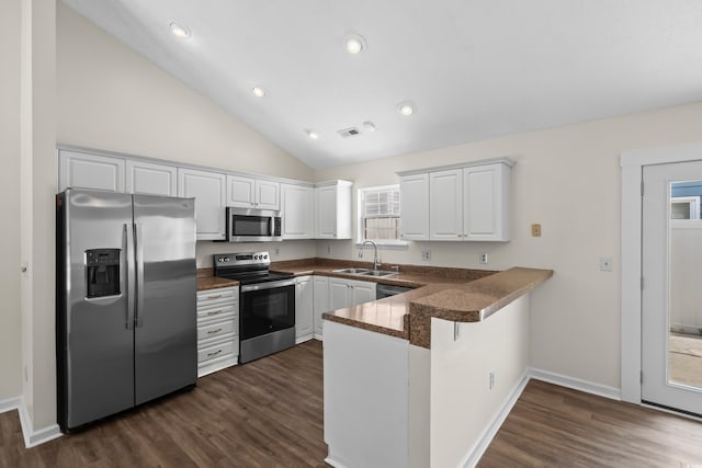 9580 Kings Rd, Myrtle Beach, SC 29572 - kitchen featuring appliances with stainless steel finishes, a peninsula, dark countertops, white cabinets, and dark wood finished floors
