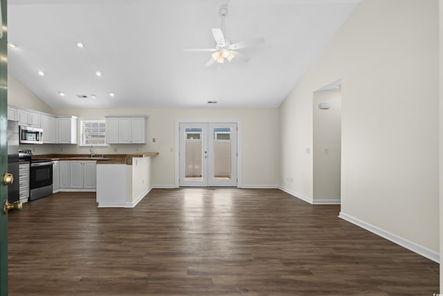 9580 Kings Rd, Myrtle Beach, SC 29572 - kitchen featuring stainless steel appliances, vaulted ceiling, ceiling fan, white cabinetry, and open floor plan