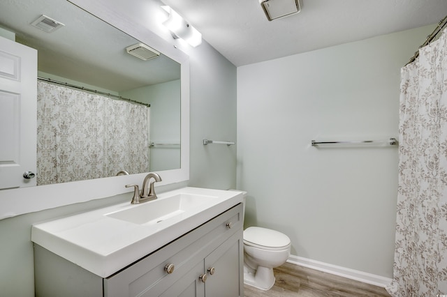 1200 5th Ave N Unit 1207, Surfside Beach, SC 29575 - bathroom with wood finished floors, vanity, toilet, and baseboards