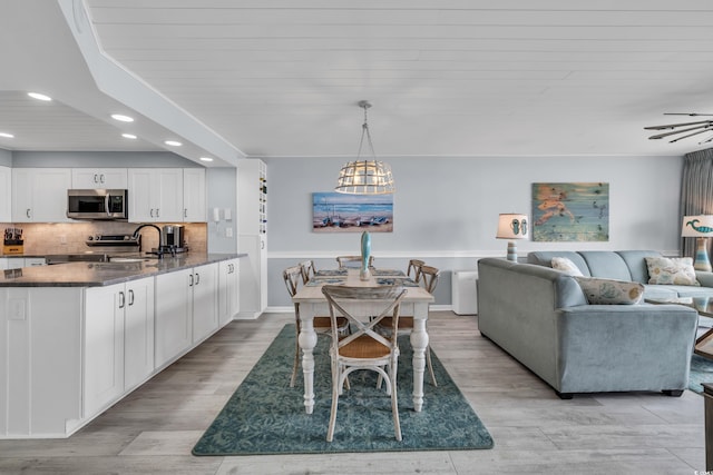 1625 S Ocean Blvd Unit 211, North Myrtle Beach, SC 29582 - dining space featuring recessed lighting, light wood-style floors, and a chandelier