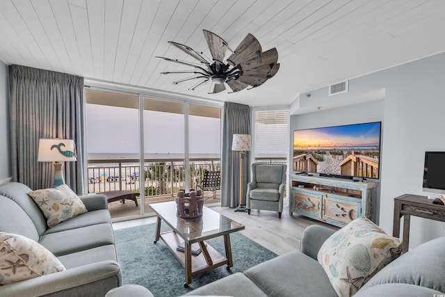 1625 S Ocean Blvd Unit 211, North Myrtle Beach, SC 29582 - living room with floor to ceiling windows, wood finished floors, and wood ceiling