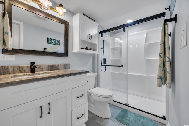 1625 S Ocean Blvd Unit 211, North Myrtle Beach, SC 29582 - bathroom with vanity, a shower stall, and wood finished floors
