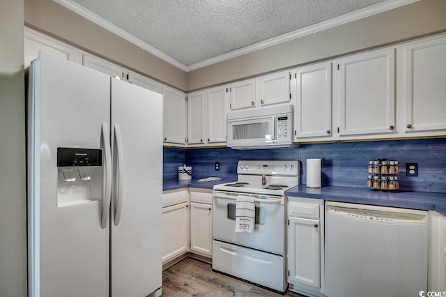 211 N Hillside Dr Unit 204, North Myrtle Beach, SC 29582 - kitchen with white appliances, dark countertops, white cabinetry, crown molding, and wood finished floors