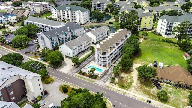 211 N Hillside Dr Unit 204, North Myrtle Beach, SC 29582 - drone / aerial view of a pool and a nearby body of water