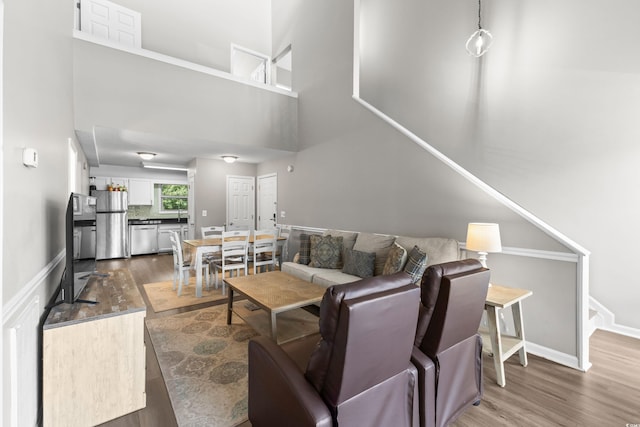 1356 Glenns Bay Rd Unit A202, Surfside Beach, SC 29575 - living area with dark wood-style floors, stairway, and a towering ceiling