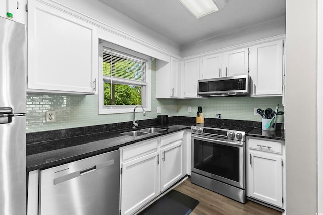 1356 Glenns Bay Rd Unit A202, Surfside Beach, SC 29575 - kitchen featuring appliances with stainless steel finishes, white cabinets, backsplash, and dark wood-style floors