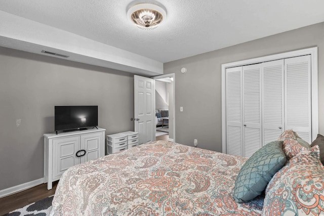 1356 Glenns Bay Rd Unit A202, Surfside Beach, SC 29575 - bedroom featuring dark wood finished floors, a closet, and a textured ceiling