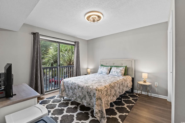 1356 Glenns Bay Rd Unit A202, Surfside Beach, SC 29575 - bedroom with wood finished floors, access to exterior, and a textured ceiling