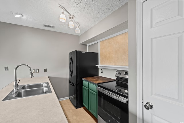 4101 Pinehurst Cir Unit Aa-3, Little River, SC 29566 - kitchen with stainless steel electric range, a sink, green cabinets, freestanding refrigerator, and a textured ceiling