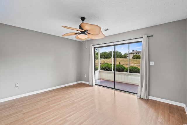 4101 Pinehurst Cir Unit Aa-3, Little River, SC 29566 - empty room with baseboards, wood finished floors, ceiling fan, and a textured ceiling