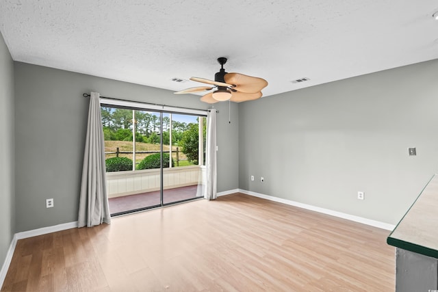 4101 Pinehurst Cir Unit Aa-3, Little River, SC 29566 - unfurnished room featuring light wood-type flooring, a ceiling fan, baseboards, and a textured ceiling