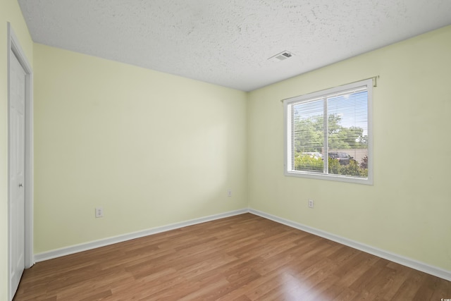 4101 Pinehurst Cir Unit Aa-3, Little River, SC 29566 - unfurnished bedroom with wood finished floors, baseboards, and a textured ceiling