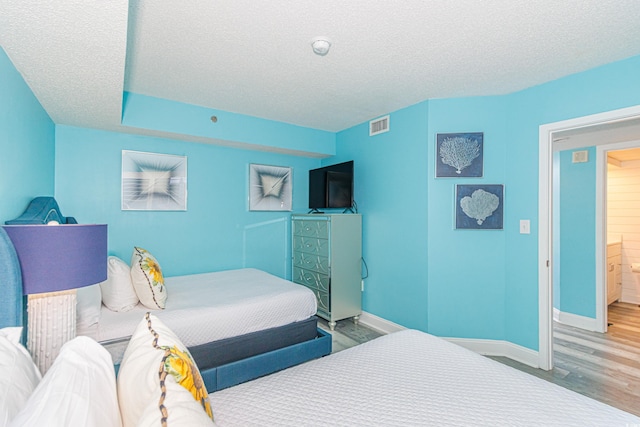 161 Sea Watch Dr Unit 601, Myrtle Beach, SC 29572 - bedroom featuring wood finished floors and a textured ceiling