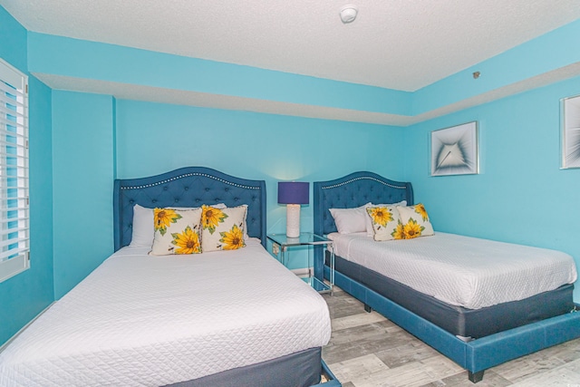 161 Sea Watch Dr Unit 601, Myrtle Beach, SC 29572 - bedroom featuring wood finished floors and a textured ceiling