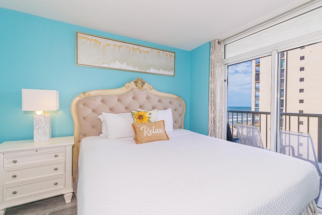 161 Sea Watch Dr Unit 601, Myrtle Beach, SC 29572 - bedroom featuring access to outside, wood finished floors, and a water view