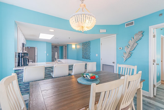 161 Sea Watch Dr Unit 601, Myrtle Beach, SC 29572 - dining area featuring a chandelier, light wood-type flooring, and recessed lighting