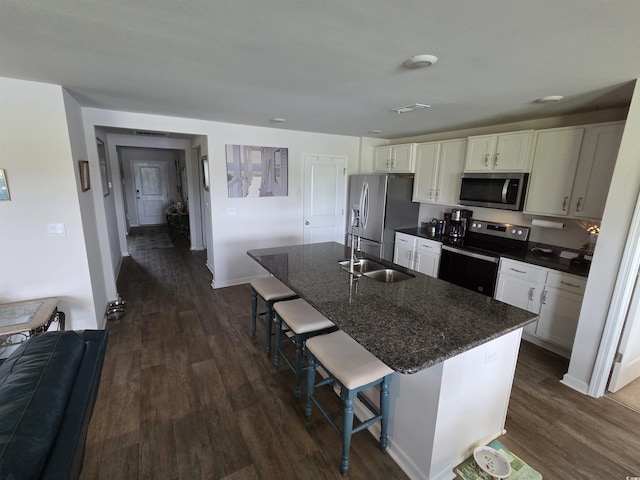 297 Harvest Ridge Way, Conway, SC 29527 - kitchen with stainless steel appliances, dark wood-style floors, a sink, a kitchen breakfast bar, and white cabinetry