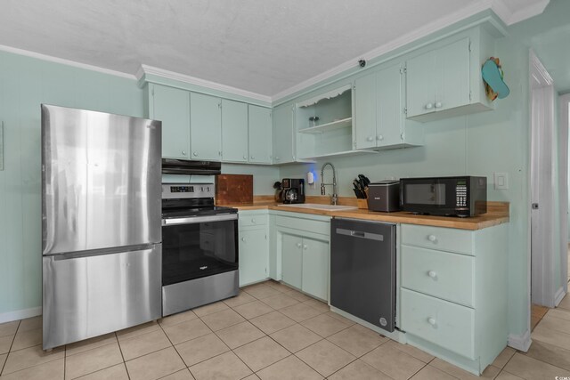 5409 N Ocean Blvd Unit 100, North Myrtle Beach, SC 29582 - kitchen with stainless steel appliances, a sink, crown molding, open shelves, and light tile patterned flooring