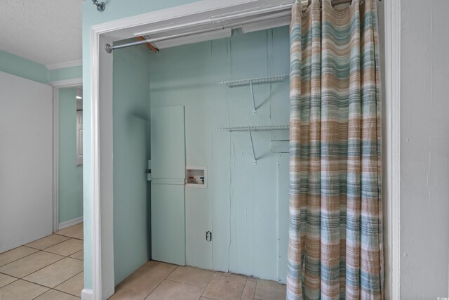 5409 N Ocean Blvd Unit 100, North Myrtle Beach, SC 29582 - washroom with light tile patterned floors and hookup for a washing machine