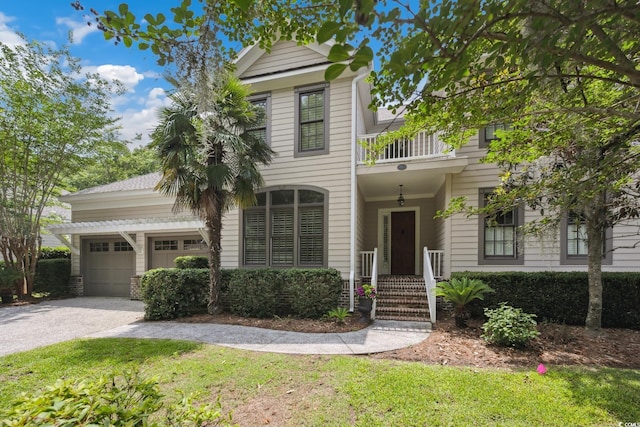 346 Tuckers Rd Unit A, Pawleys Island, SC 29585 - view of front of home featuring asphalt driveway, a garage, a balcony, and a front lawn
