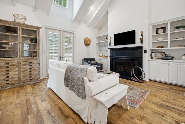 346 Tuckers Rd Unit A, Pawleys Island, SC 29585 - living area with a fireplace, beamed ceiling, light wood finished floors, and high vaulted ceiling