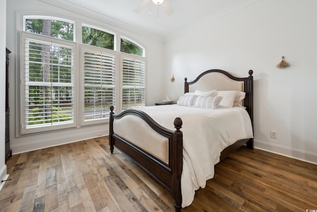 346 Tuckers Rd Unit A, Pawleys Island, SC 29585 - bedroom with baseboards, multiple windows, wood finished floors, ceiling fan, and ornamental molding