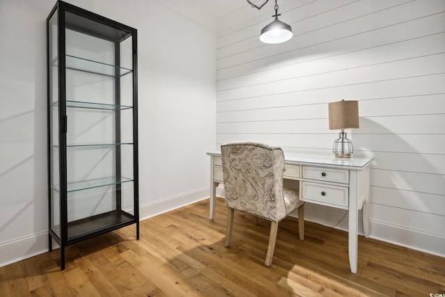 346 Tuckers Rd Unit A, Pawleys Island, SC 29585 - home office with light wood-style flooring, baseboards, and wooden walls