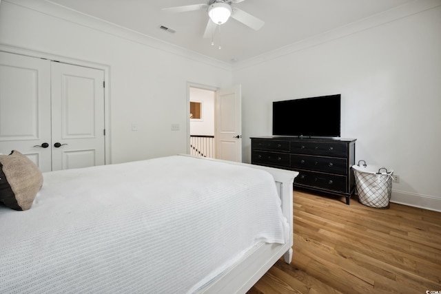 346 Tuckers Rd Unit A, Pawleys Island, SC 29585 - bedroom with ornamental molding, light wood-style flooring, a closet, ceiling fan, and baseboards