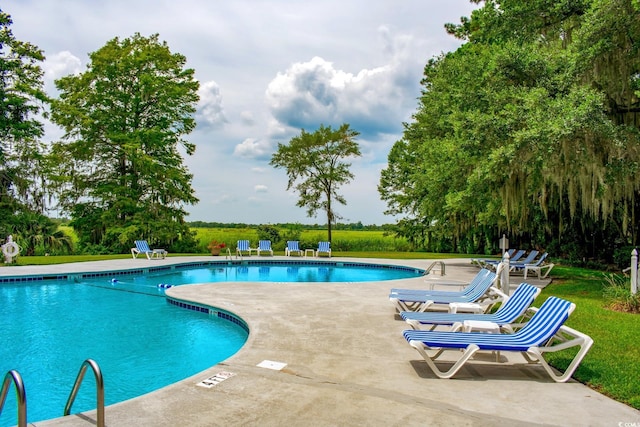 346 Tuckers Rd Unit A, Pawleys Island, SC 29585 - community pool featuring a patio and a lawn