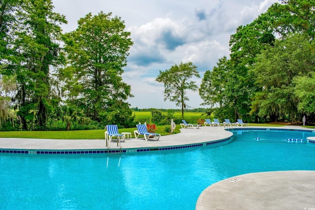 346 Tuckers Rd Unit A, Pawleys Island, SC 29585 - community pool with a patio area, view of scattered trees, and a lawn
