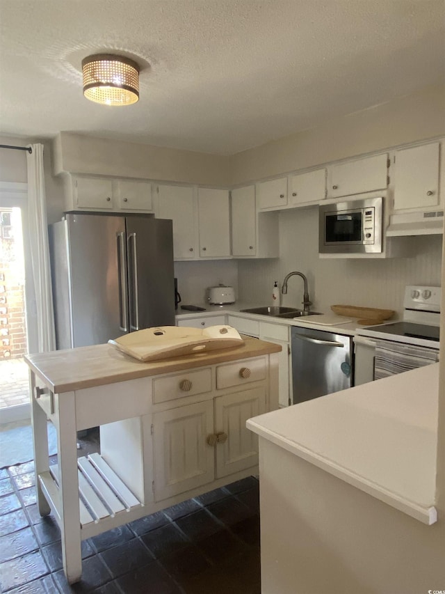 10200 Lake Shore Dr Unit 4, Myrtle Beach, SC 29572 - kitchen with appliances with stainless steel finishes, extractor fan, butcher block countertops, white cabinetry, and open shelves