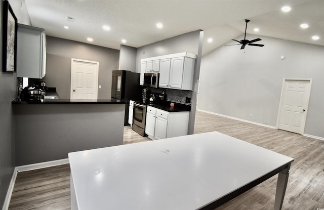 126 Clovis Cir, Myrtle Beach, SC 29579 - kitchen featuring stainless steel appliances, dark countertops, a ceiling fan, white cabinets, and light wood-style floors