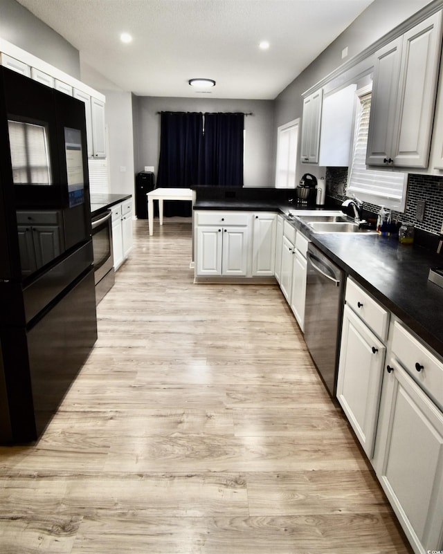 126 Clovis Cir, Myrtle Beach, SC 29579 - kitchen featuring stainless steel appliances, a sink, a peninsula, dark countertops, and decorative backsplash