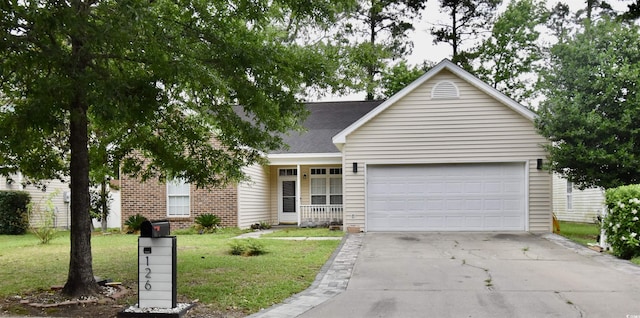 126 Clovis Cir, Myrtle Beach, SC 29579 - view of front facade featuring a front yard, a garage, concrete driveway, a shingled roof, and brick siding