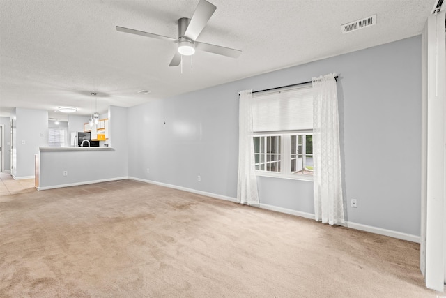820 Fairway Dr Unit 1502Hh, Longs, SC 29568 - unfurnished living room featuring a textured ceiling, light colored carpet, and ceiling fan