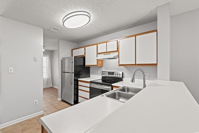 820 Fairway Dr Unit 1502Hh, Longs, SC 29568 - kitchen with stainless steel appliances, under cabinet range hood, a textured ceiling, light tile patterned flooring, and light countertops