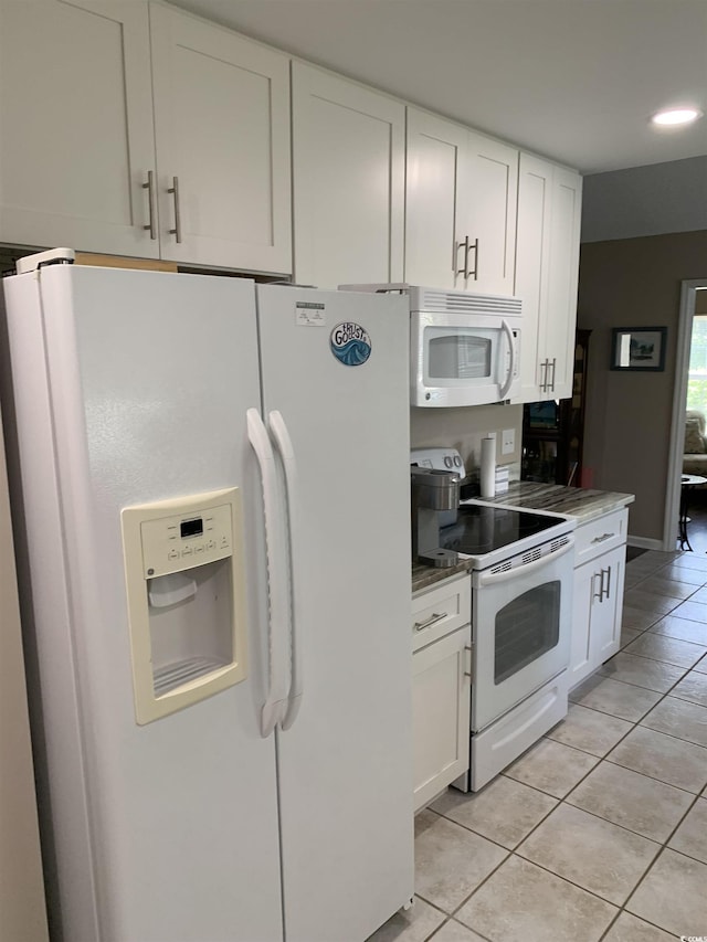 1432 Seahouse Ct, Surfside Beach, SC 29575 - kitchen with white appliances, white cabinets, and light tile patterned flooring