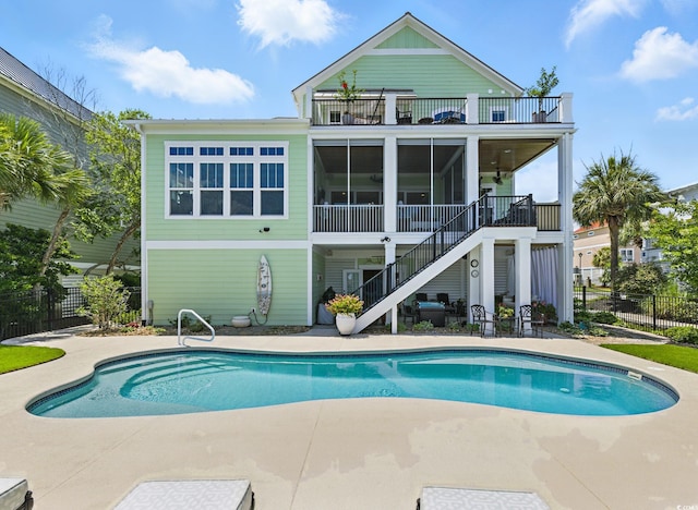 191 Grackle Ln, Pawleys Island, SC 29585 - rear view of house featuring a balcony, stairway, a patio area, and a sunroom