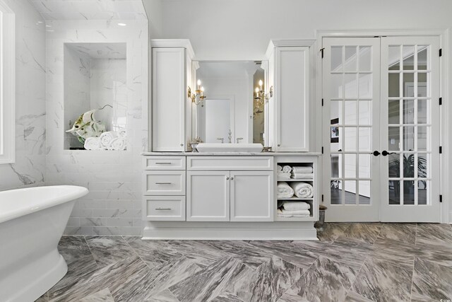 191 Grackle Ln, Pawleys Island, SC 29585 - full bath featuring a soaking tub, vanity, marble finish floors, french doors, and a chandelier