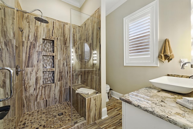 191 Grackle Ln, Pawleys Island, SC 29585 - bathroom featuring vanity, toilet, tiled shower, ornamental molding, and baseboards
