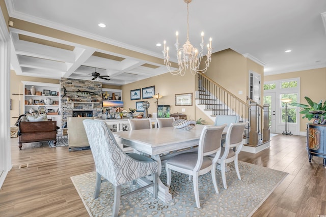191 Grackle Ln, Pawleys Island, SC 29585 - dining space featuring a ceiling fan, light wood-style flooring, a stone fireplace, a chandelier, and recessed lighting
