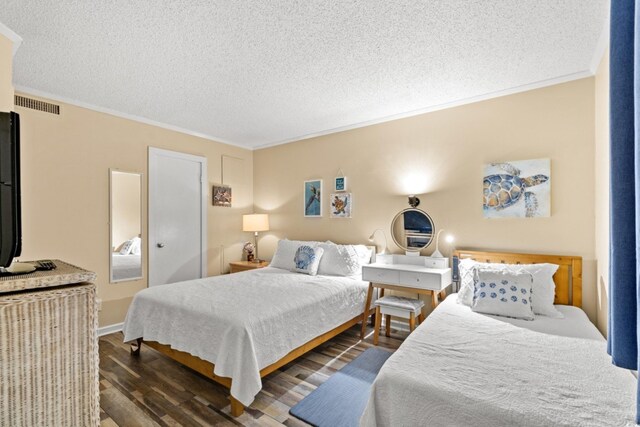 415 Ocean Creek Dr Unit 2372, Myrtle Beach, SC 29572 - bedroom featuring crown molding, dark wood-type flooring, and a textured ceiling