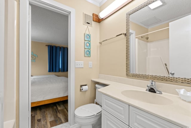 415 Ocean Creek Dr Unit 2372, Myrtle Beach, SC 29572 - ensuite bathroom with vanity, toilet, wood finished floors, a textured ceiling, and a shower