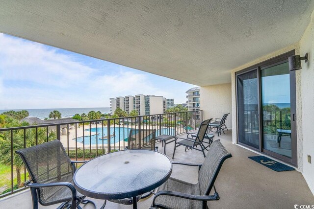 341 S Dunes Dr Unit C-34, Pawleys Island, SC 29585 - balcony with view of pool and a water view