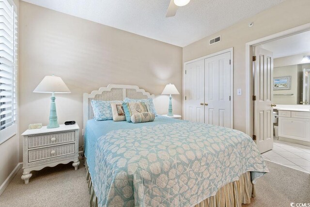 341 S Dunes Dr Unit C-34, Pawleys Island, SC 29585 - bedroom featuring light colored carpet, a closet, baseboards, ceiling fan, and connected bathroom