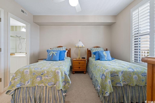 341 S Dunes Dr Unit C-34, Pawleys Island, SC 29585 - bedroom with carpet, multiple windows, connected bathroom, and a ceiling fan